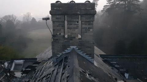 WE CLIMB DANGEROUS ROOF TO SEE VIEW OVER THE CITY...