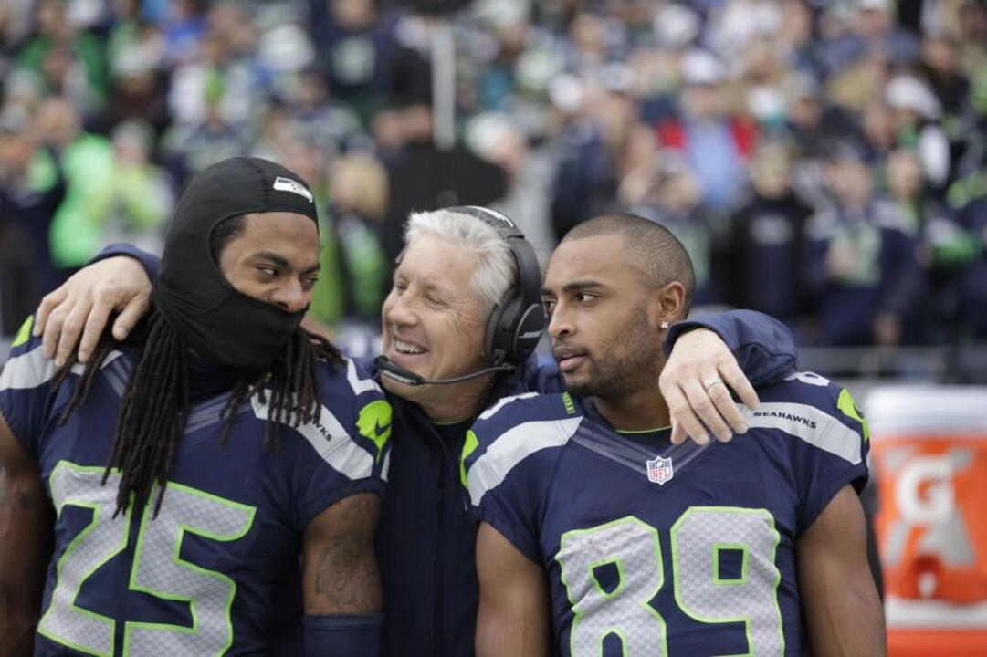 Seattle Seahawks corner back Richard Sherman (25) gives a hug to