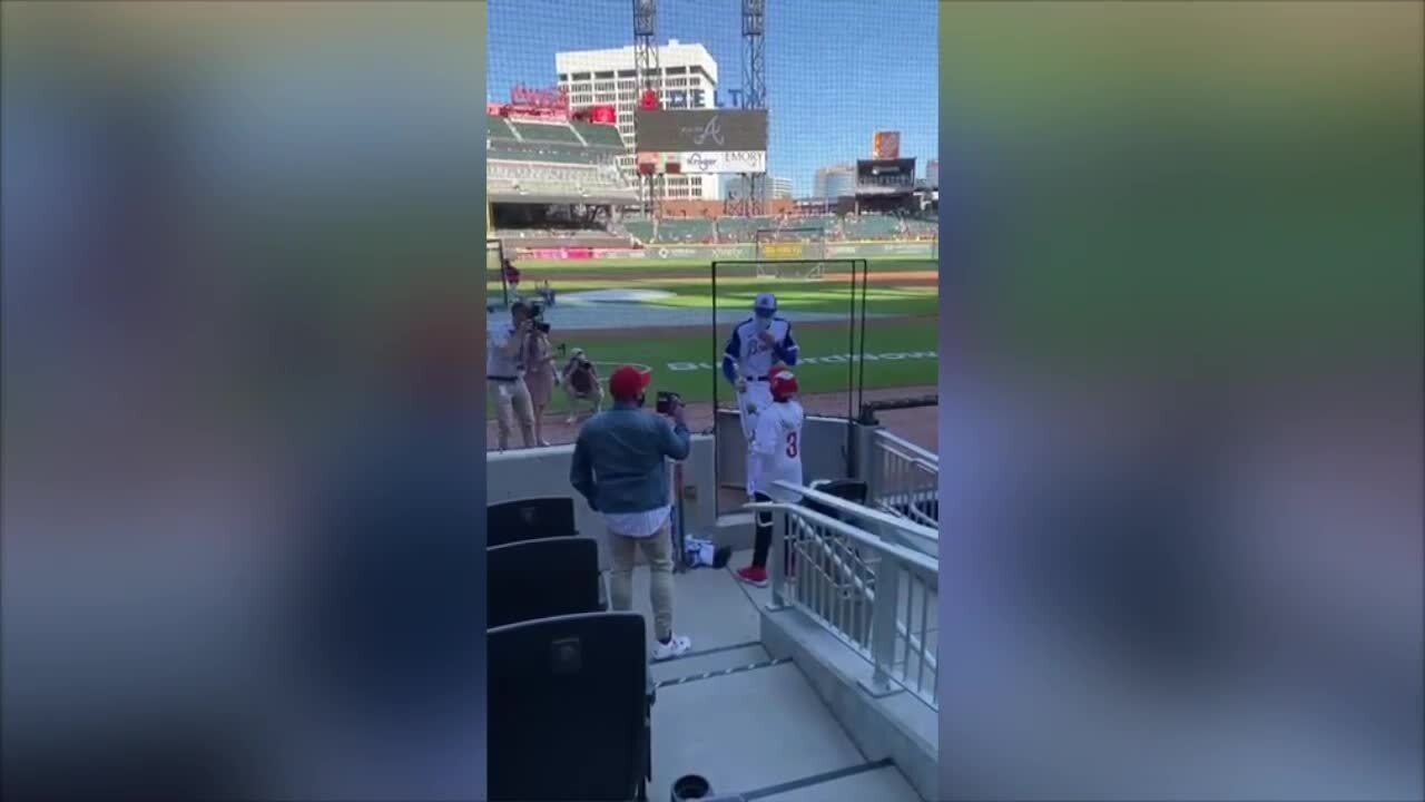 Baseball player Freddie Freeman surprises a young Phillies fan who gave  away a home run ball to a Braves fan