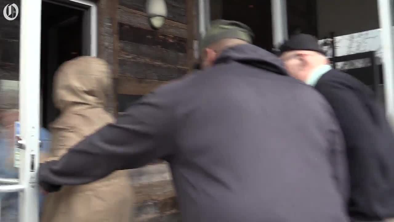 Local activist Andrew Woods leads protesters to Pizza Peel Charlotte