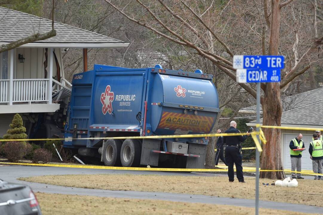 Trash truck crushes corner of house in Prairie Village, driver in
