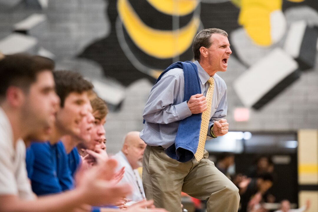 Lexington coach Bailey Harris uses a towel to chew on during basketball