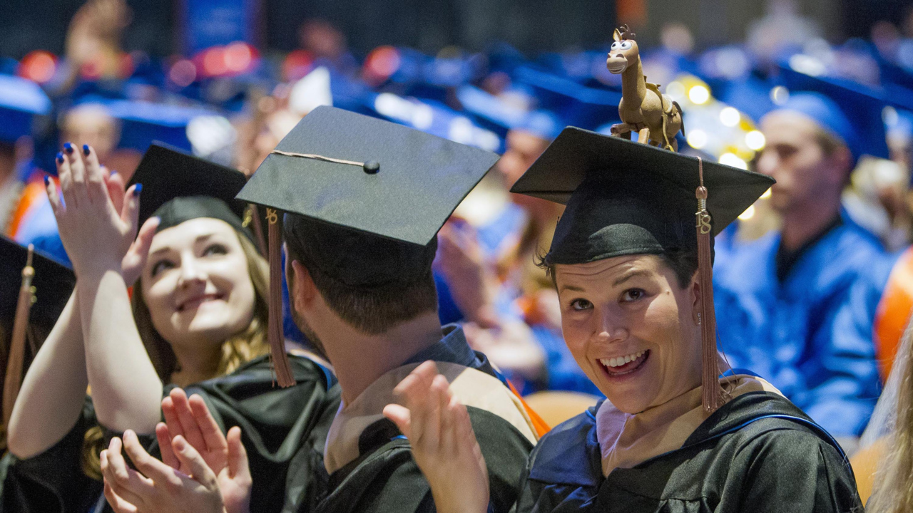 Boise State graduates decorate their caps for spring commencement at