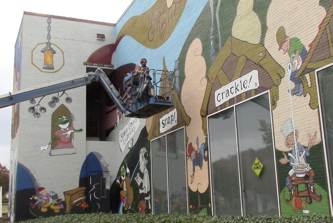 Muralist, artist detail work of famed Rock Hill illustrator in mural
