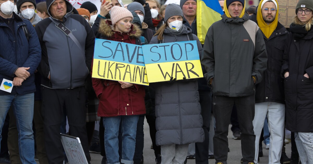 People attend a pro-Ukraine protest rally in front of the Hofburg palace in Vienna, Austria, Friday, Feb. 25, 2022 the day after Russian troops have launched their anticipated attack on Ukraine. (A...