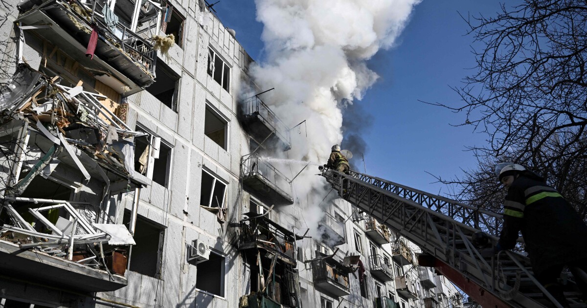 Firefighters work on a fire on a building after bombings on the eastern Ukraine town of Chuguiv on February 24, 2022, as Russian armed forces are trying to invade Ukraine from several directions, u...