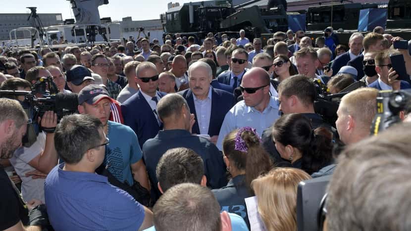 Belarusian President Alexander Lukashenko, center, surrounded by his bodyguards listens to an employee of the Minsk Wheel Tractor Plant in Minsk, Belarus, Monday, Aug. 17, 2020. Workers heckled Pre...