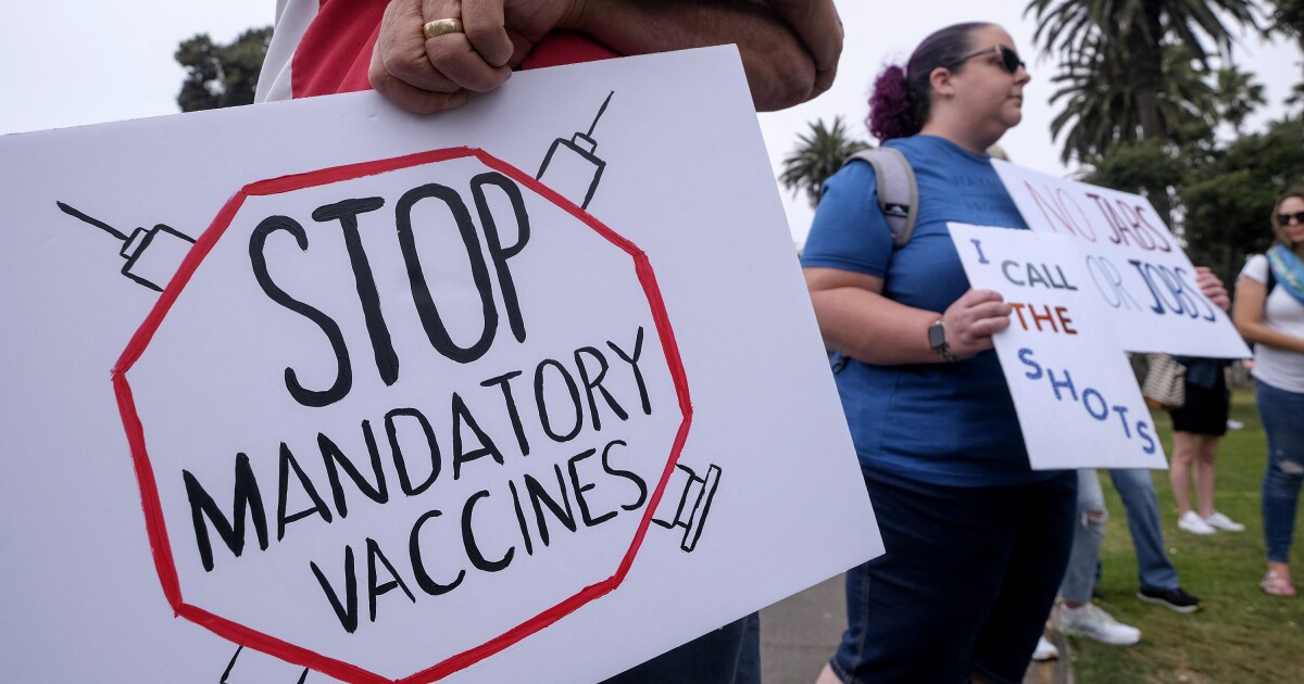 Anti-vaccination protesters holding signs take part in a rally against Covid-19 vaccine mandates, in Santa Monica, California, on August 29, 2021. (Photo by RINGO CHIU / AFP) (Photo by RINGO CHIU/A...