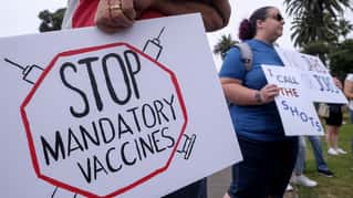 Anti-vaccination protesters holding signs take part in a rally against Covid-19 vaccine mandates, in Santa Monica, California, on August 29, 2021. (Photo by RINGO CHIU / AFP) (Photo by RINGO CHIU/A...