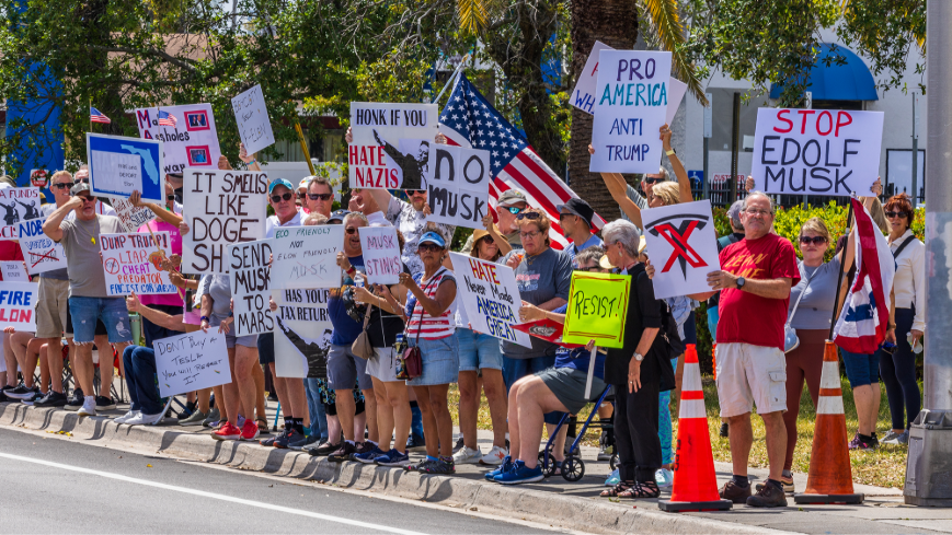 People protested against Elon Musk outside of a Fort Lauderdale Tesla showroom