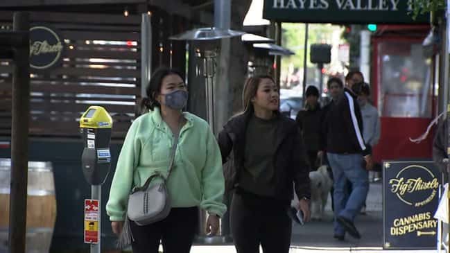 Experts say it could be months before people are comfortable without face masks