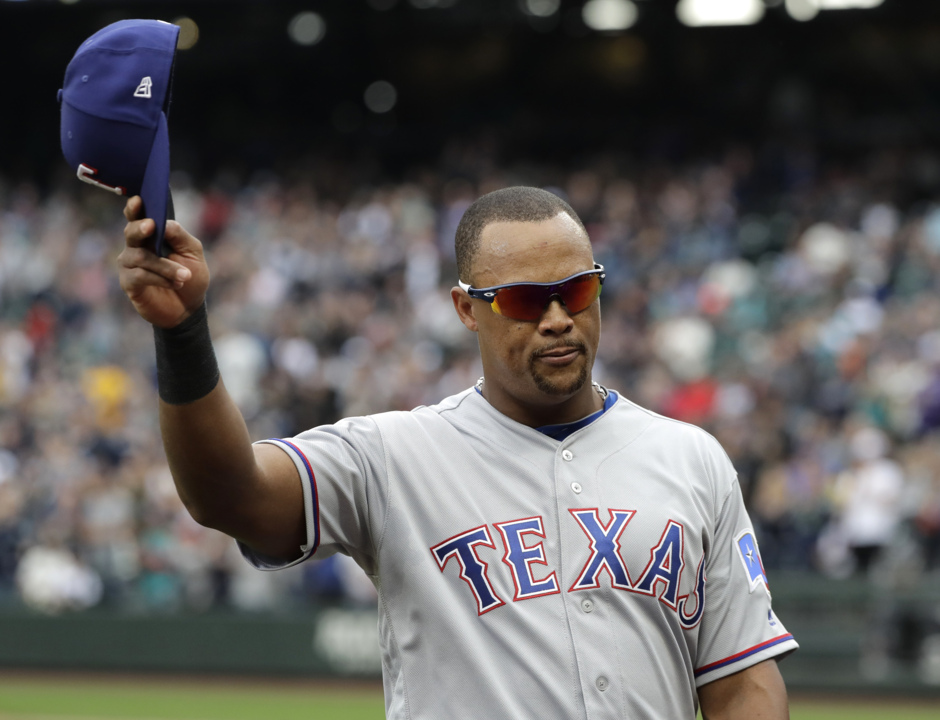 Retired Texas Rangers player Adrian Beltre, left, is presented with a gift  by shortstop Elvis Andrus from the team during a jersey retirement ceremony  for him before the second baseball game of