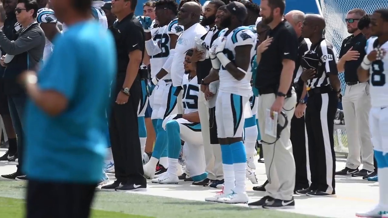 Panthers salute service members; safety Eric Reid kneels during anthem