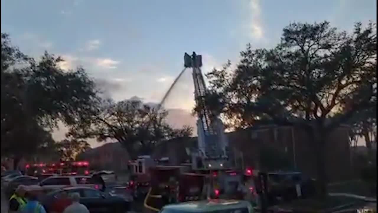 Firefighters work to put out fire at Carlton Arms apartments