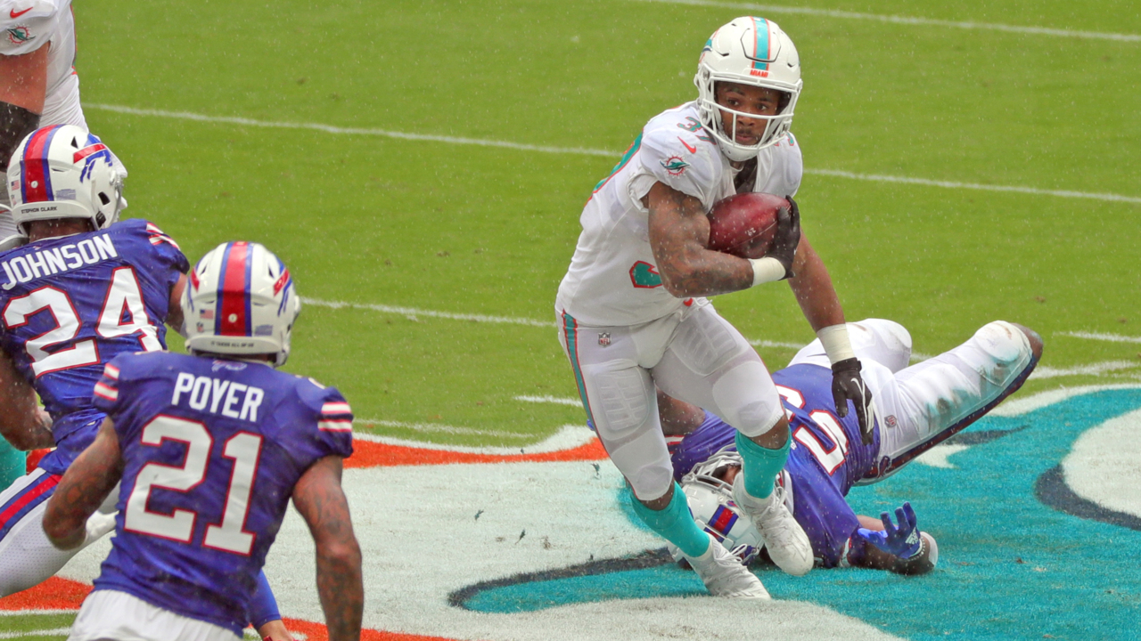 Miami Dolphins running back Myles Gaskin, left, is tackled by New England  Patriots cornerback Joejuan Williams, right, during the second half of an  NFL football game, Sunday, Sept. 12, 2021, in Foxborough