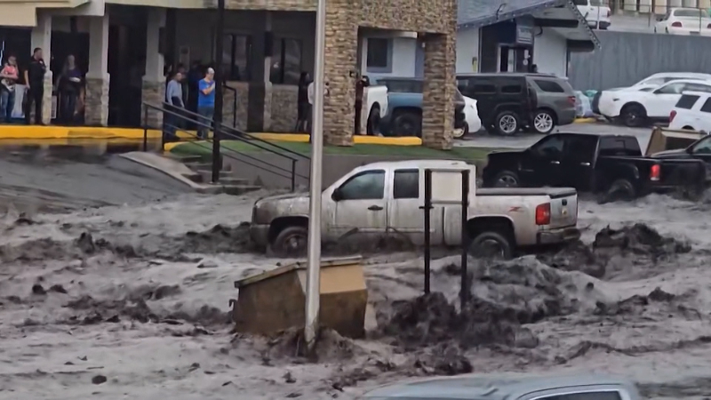 Road in New Mexico town turned into raging river amid flooding