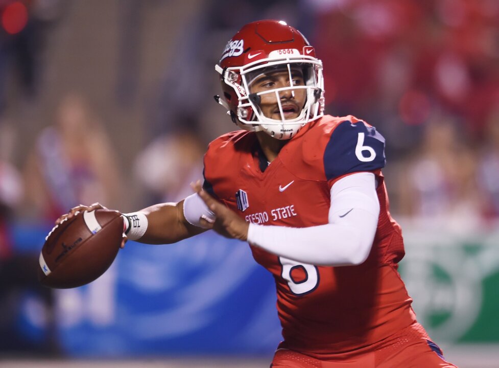 Fresno State quarterback Marcus McMaryion raises the trophy in celebration  of his team's win ov …