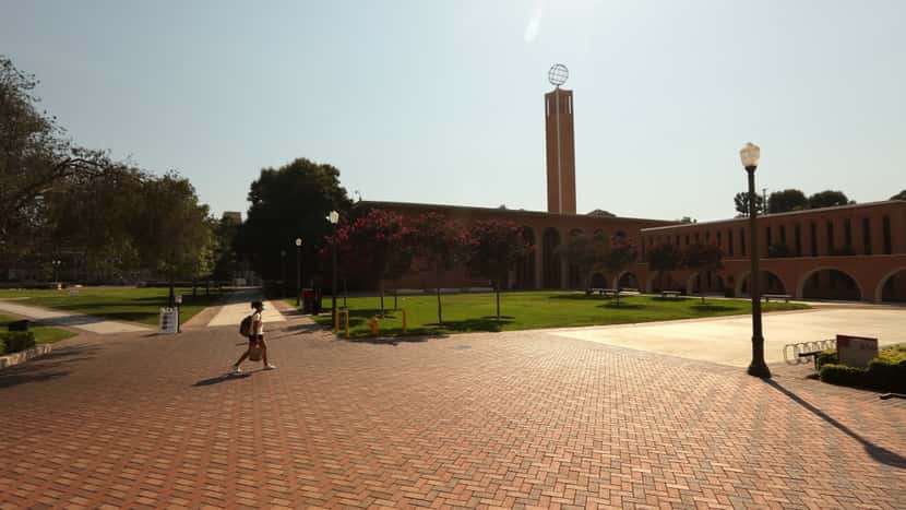 LOS ANGELES, CA - AUGUST 17, 2020 - - A lone student walks across an empty section of the USC campus on the first day of academic instruction for the Fall 2020 semester in Los Angeles on August 17,...