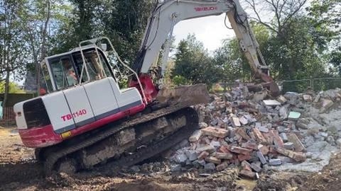 DIGGER CLIMBS RUBBLE PILE. DOES HE FALL?