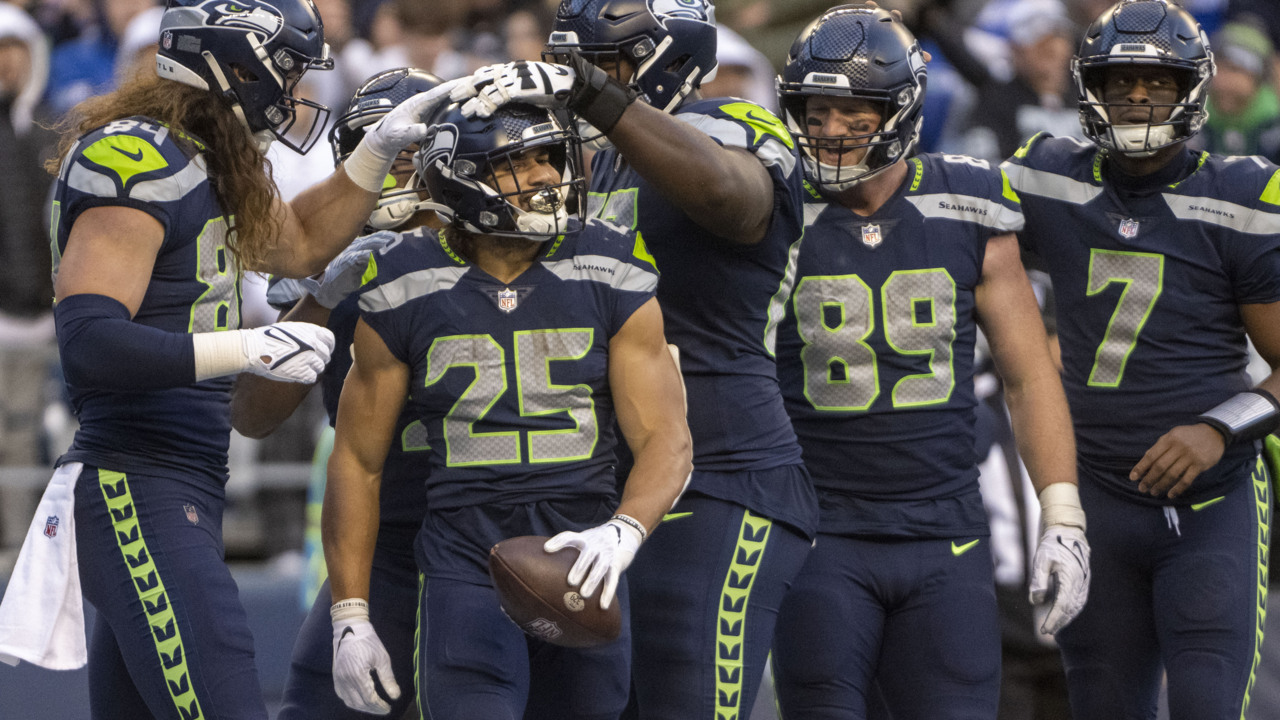 Seattle Seahawks running back Travis Homer (25) toplles over Pittsburgh  Steelers safety Tre Norwood (21) on a run during the first half of an NFL  preseason football game, Saturday, Aug. 13, 2022