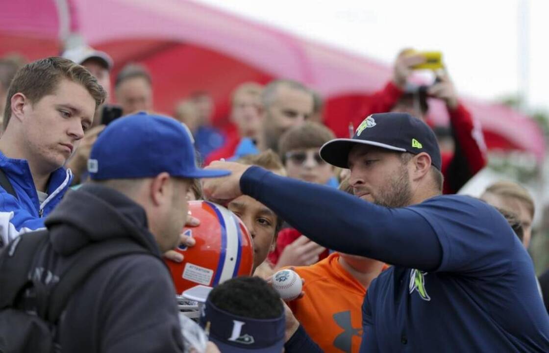 Jerseys worn by Tim Tebow fans commemorate the various phases of his  athletic career