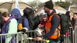 Young Ukrainian refugee delighted by lollipops at Polish border