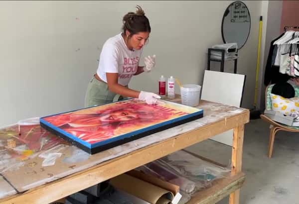 Sarasota artist creates a portrait of Olivia Newton-John using only lipstick